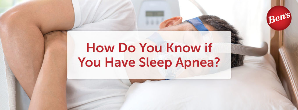 Man laying in bed wearing a sleep apnea mask.